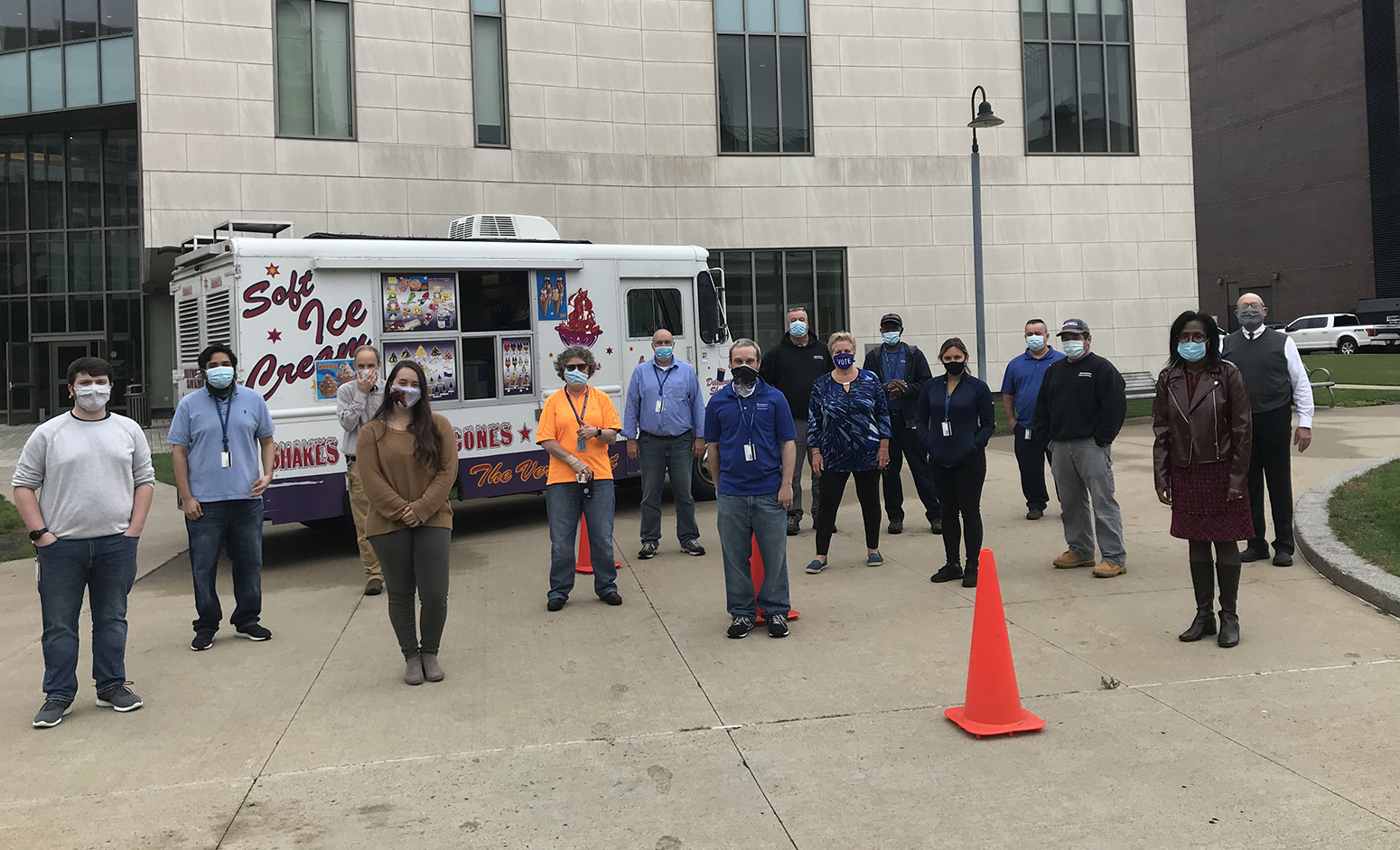 Employees standing in front of ice cream truck